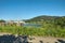 Lagoon, flowers, houses and hill in valley of Labe river in czech republic