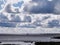 Lagoon near coast under sky with ships on the horizon