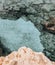 Lagre stones in the water. Rocky seabed with white sand and clear blue water, top view. Mediterranean Sea near Cyprus.