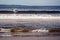 Lahinch town, Ireland - 08.06.2020 : Beautiful women surfing in the ocean in wet suit. Atlantic ocean. Outdoor activity, Aqua