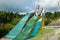 Lahti, Finland - 4 August 2020: Lahti sports centre with three ski jump towers. Sportsman is jumping from the smallest ski jump