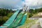 Lahti, Finland - 4 August 2020: Lahti sports centre with three ski jump towers. Sportsman is jumping from the smallest ski jump