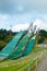 Lahti, Finland - 4 August 2020: Lahti sports centre with three ski jump towers. Sportsman is jumping from the smallest ski jump