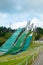 Lahti, Finland - 4 August 2020: Lahti sports centre with three ski jump towers. Sportsman is jumping from the smallest ski jump