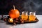 Laid table served with orange drinks is traditionally decorated with cut out jack-o\\\'-lanterns and lights for Halloween