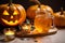 Laid table served with orange drinks is traditionally decorated with cut out jack-o\\\'-lanterns and lights for Halloween