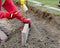 Laing edging kerb on semidry concrete during roadworks and new footpath construction  by groundworker wearing safety gloves