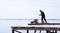 LAISHEVO, RUSSIA-MAY 4, 2020. a lone fisherman catches fish from a wooden pier on the banks of the Kama river