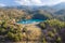 Lake in abandoned mine pit and waste heaps over mountains landscape in Xyliatos, Cyprus