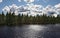 Lake amongst the woods, cloudy summer sky, Sweden