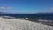 Lake of the Argentine south. Beach of white stones. Crystal clear water and mountains in background.