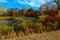 Lake in autumn forest under swimming by clouds