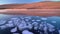 Lake Baikal clear ice with circle white layered bubble. Frozen water and hill mountain on sunny