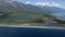 Lake Baikal coast and snowcapped mountain summer drone. Beach sand strip. Green forest woods