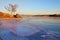 Lake Baikal in December. View of the frozen Kurkut Bay in the rays of the setting sun.