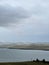 Lake Baikal in the early morning, foggy haze over the water. Gloomy harsh landscape