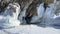 Lake Baikal grotto. Ice cave on a frozen lake. Powerful rocky mountains covered with ice and icicles