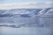 Lake Baikal ice. Mountain shore. Winter landscape