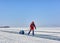 LAKE BAIKAL, IRKUTSK REGION, RUSSIA - March 08, 2017: Man in an orange polar overalls is skating