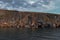 Lake Baikal, Rocky red stones shore with cliffs, reflection in ripples