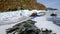 Lake Baikal, Russia - February 20, 2023: Tourists walk on the ice of the frozen Lake Baikal