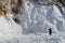 Lake Baikal in winter, ice formations, icicles, snow landscape, woman taking photos