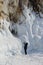 Lake Baikal in winter, ice formations, icicles, snow landscape, woman taking photos