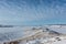 Lake Baikal in winter, ice under snow, hills, sunny day, Siberia