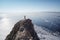 Lake Baikal at winter. Man standing on a cliff and looking at frozen Baikal lake