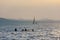Lake Balaton at sunset in back light with sailboats and bathers