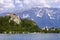 Lake Bled. Slovenian Alps. Julian Alps in summer. Medieval castle and St. Martins Parish Church with mountains in background. Sky