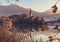 Lake Bled at Sunrise. Church, castle and the mountains are basking in the morning sun