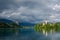 Lake Bled, view of the castle and church in stormy weather with sunshine after rain