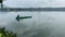 Lake boatman loading wire fish trap on his wooden row boat