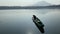 Lake boatman loading wire fish traps on his wooden row boat