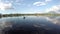 Lake boatman paddles his bamboo raft across mountain lake