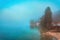 Lake Bohinj in Slovenia, beautiful scenic landscape of glacial body of water in Slovenian national park Triglav in foggy morning