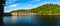 Lake Bystrzyckie located in a mountain valley, a dam on the Bystrzyca River, view from the lake shore on a sunny summer day