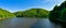 Lake Bystrzyckie located in a mountain valley, green forest on the slopes of the mountains, view from the dam on the Bystrzyca