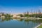 A lake with a calm water, blue sky and reflected vegetation.