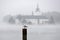 Lake castle Ort in Gmunden in the autumn fog with a seagull in the foreground, Austria, Europe