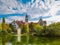 Lake in center of Wroclaw Tolpa Park with fountain in center with faculty of architecture