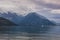 Lake Comersee with mountains and sailing boat, dramatic clouds, Italy