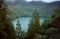 A lake in the crater of a volcano surrounded by a dense forest. Azores