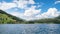 Lake Davosersee with surfers, blue sky with clouds