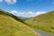 Lake District valley and mountains between Buttermere and Keswick Cumbria England uk with blue sky and clouds and shadows