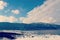 Lake dock in winter with snow covered mountains