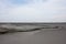 Lake of dry mud formed from a mud volcano eruption in Sidoarjo, East Java, Indonesia with clouds in blue sky