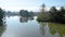 Lake at the edge of the mountains with forest reflected in the clear water. Idyllic autumn landscape. The forest and the sky in th