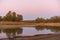 Lake Embalse de Piedra Aguda dam near Olivenza, Spain at sunset with beautiful reflection on the water